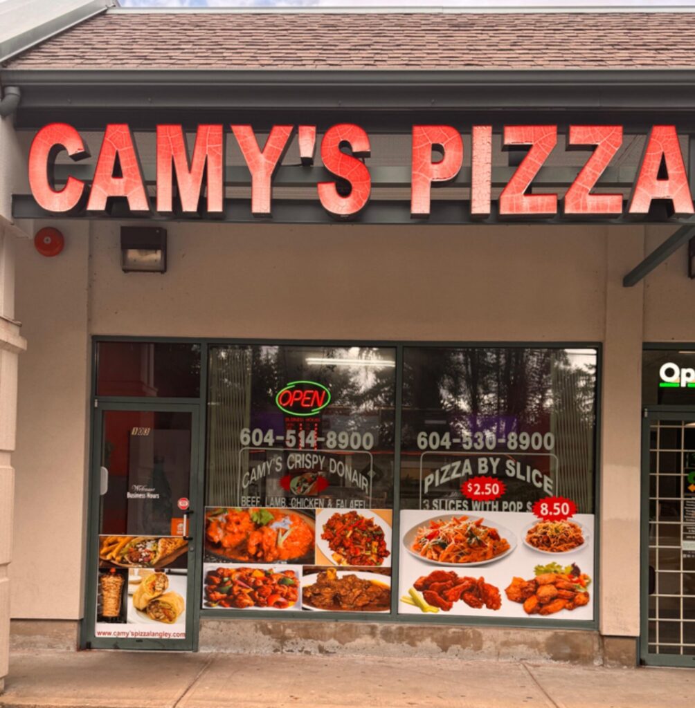 a store front with signs on the windows
